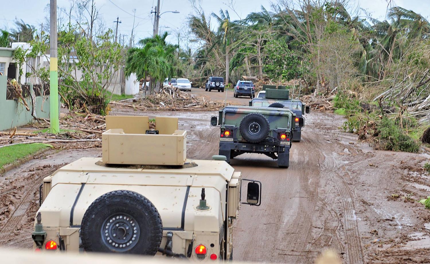 The PR National Guard drives through some of the devastated areas of remote villages after Hurricane Maria tore through the island.