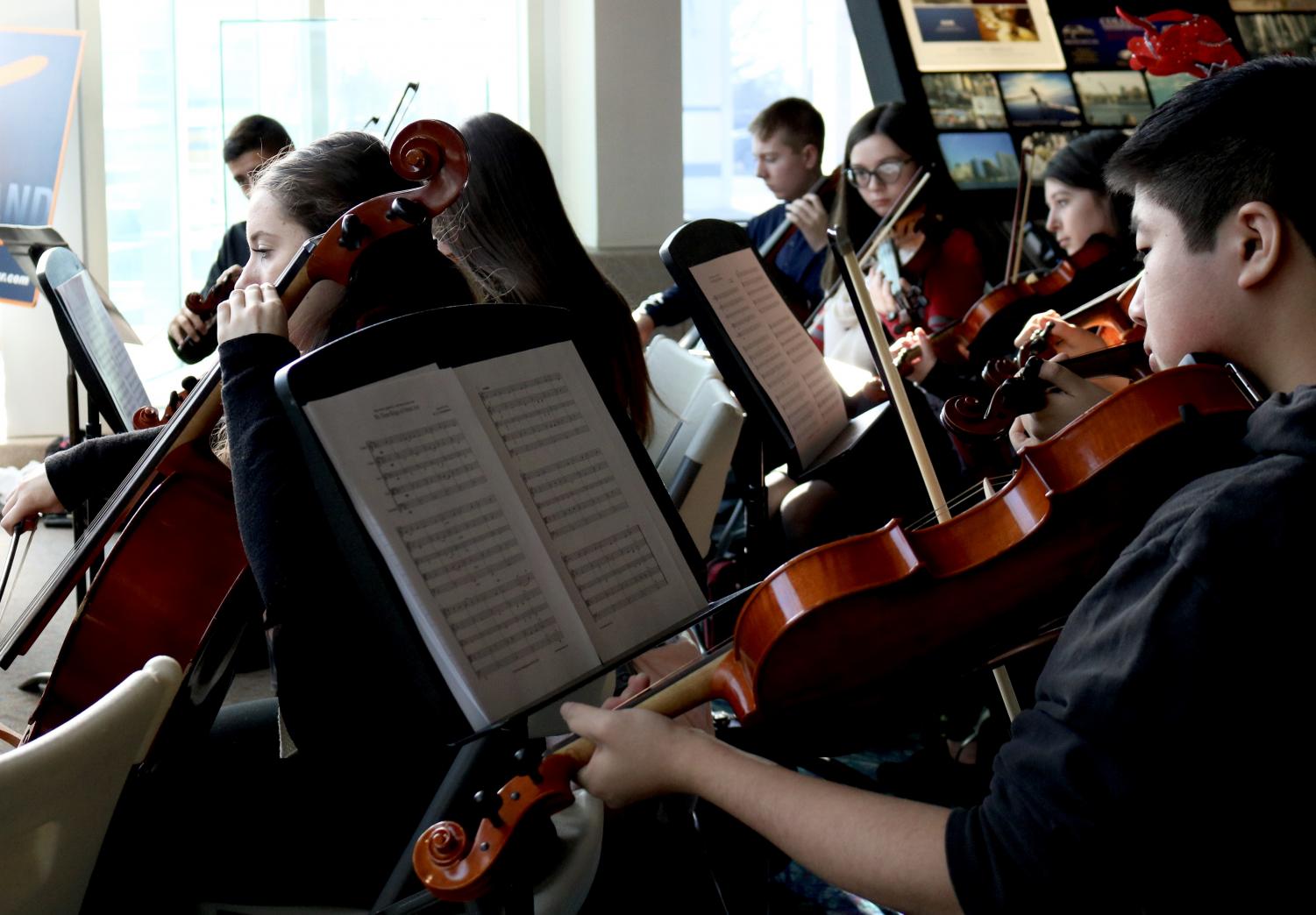 Orchestra students participate in events beyond the traditional school concert. Each year, they perform free for the public at the airport welcoming arrivals to Long Island and serenading waiting passengers to get them in the holiday spirit.