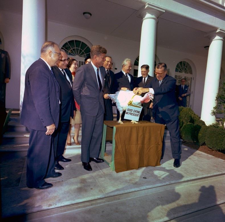 President JFK poses with turkey in long-standing White House tradition.