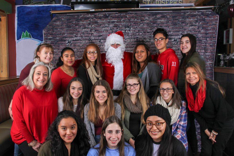 PMHS volunteers pose for a photo with Santa at annual fundraiser.