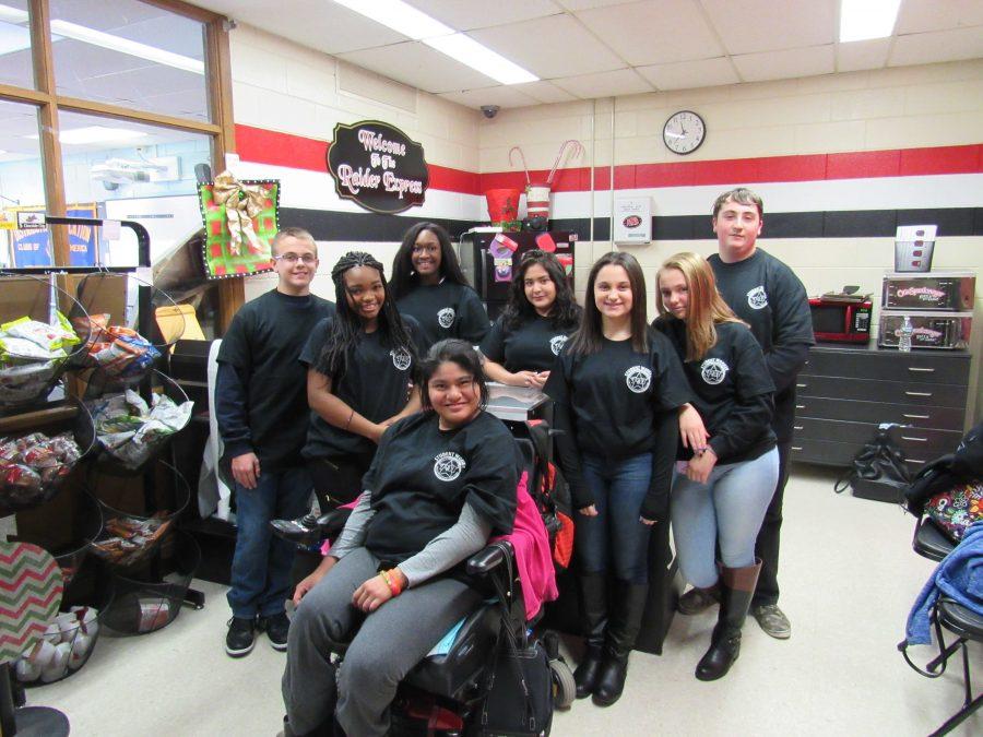 The staff at the school store. New gear now available online! Click the link in the article.