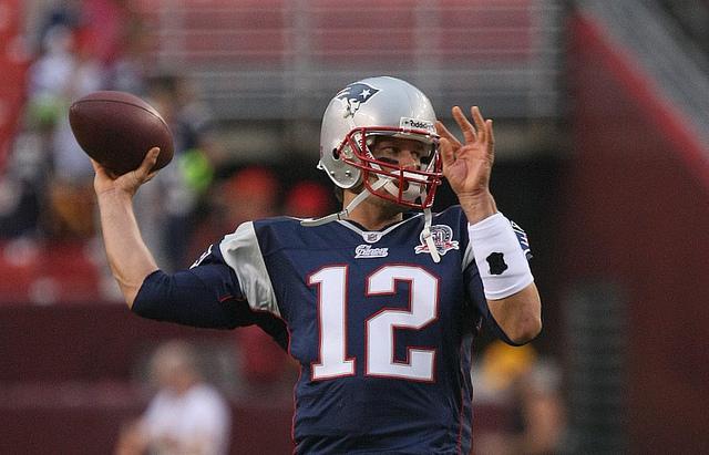 Tom Brady, 12, quarterback for the New England Patriots sets up a pass