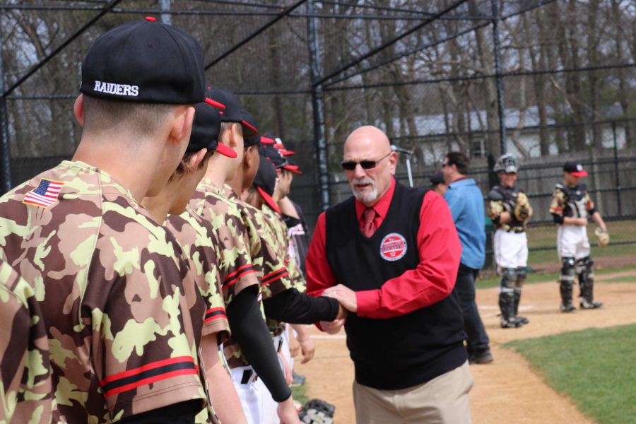 Manny Felouzis shakes hands with players prior to the game against the Brentwood Indians on Saturday, April 5. 