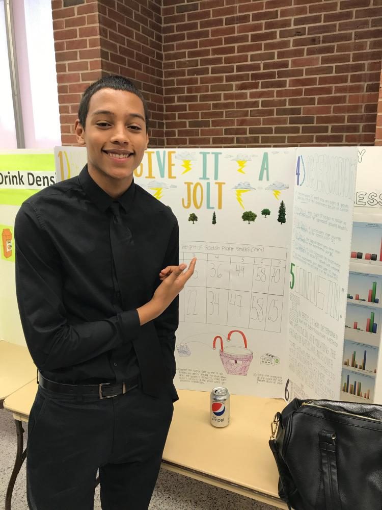 Tristan Moreau poses with his experiment that earned him special opportunity to attend an event at the Brookhaven National Laboratory.