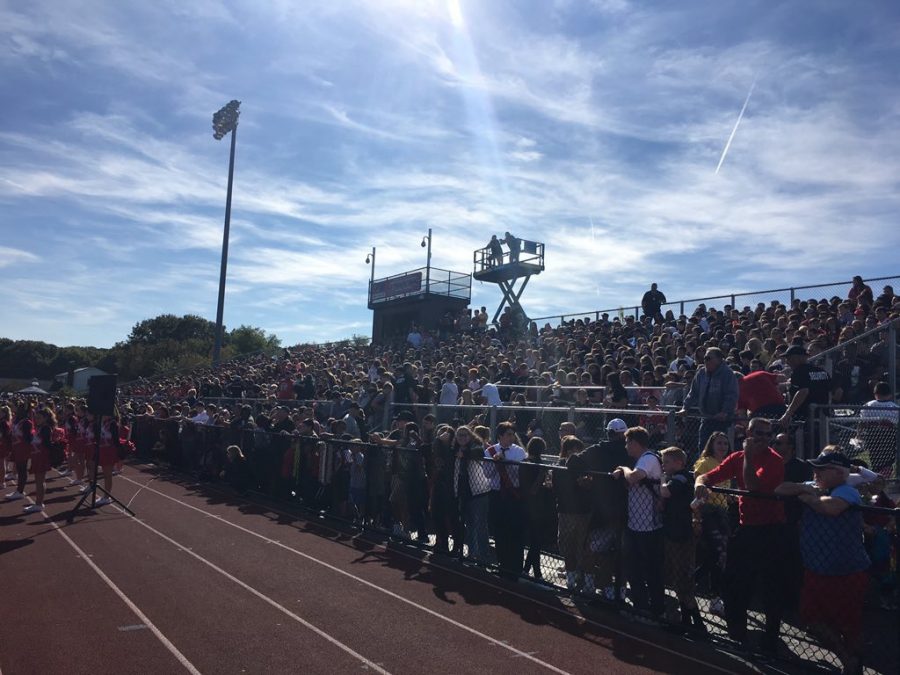 Fans fill the stands to watch the football game and halftime show on Homecoming day.