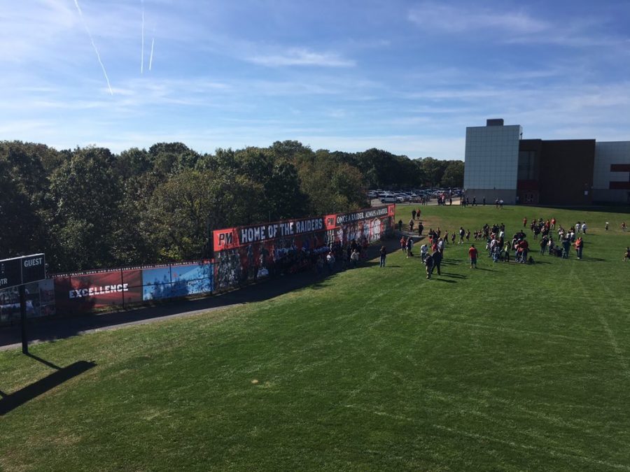 Spectators can be seen viewing our new windscreens that display school colors and community pride on Homecoming day.