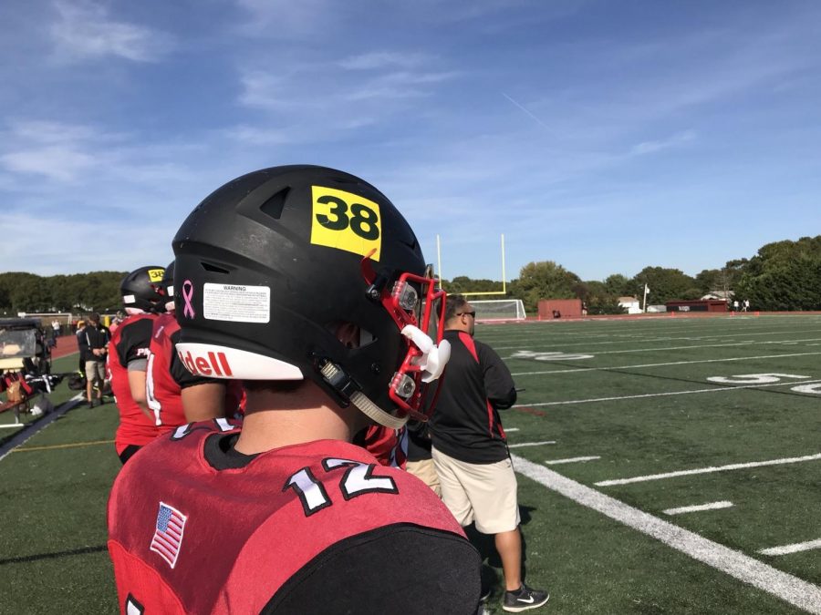 Pat-Med football players salute classmate Sean Dixon by wearing his number on their helmets.