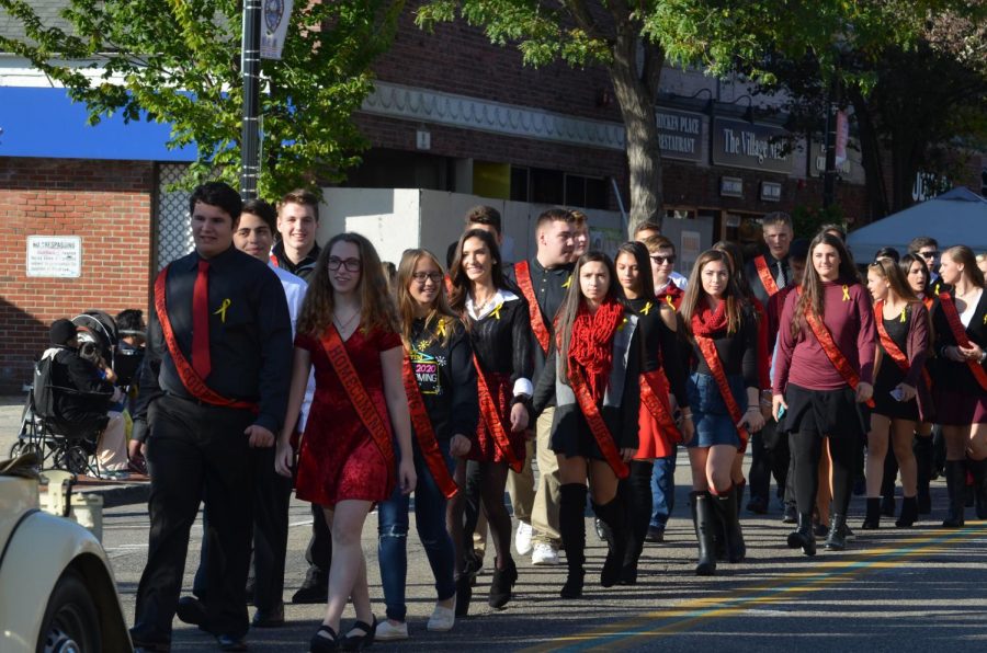 Homecoming court marches down Main Street during the parade.