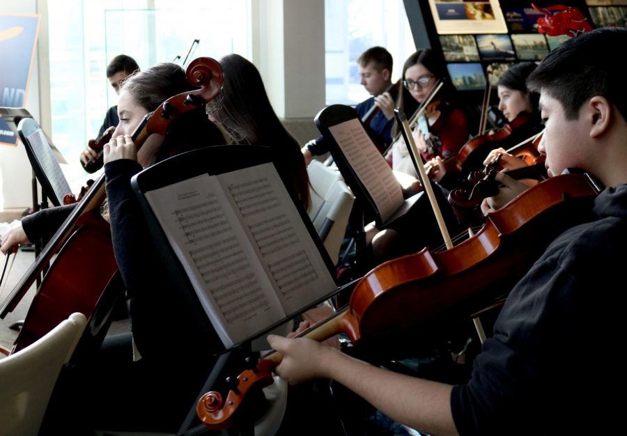 Orchestra students participate in events beyond the traditional school concert. Each year, they perform free for the public at the airport welcoming arrivals to Long Island and serenading waiting passengers to get them in the holiday spirit. 