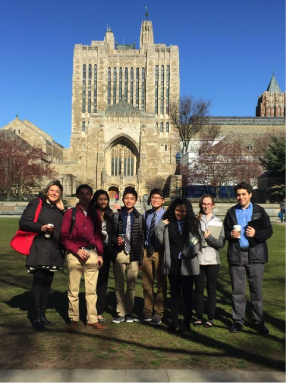 Students and Model UN advisor Ms. Botta stand in front of the Yale University Sterling Memorial Library.

