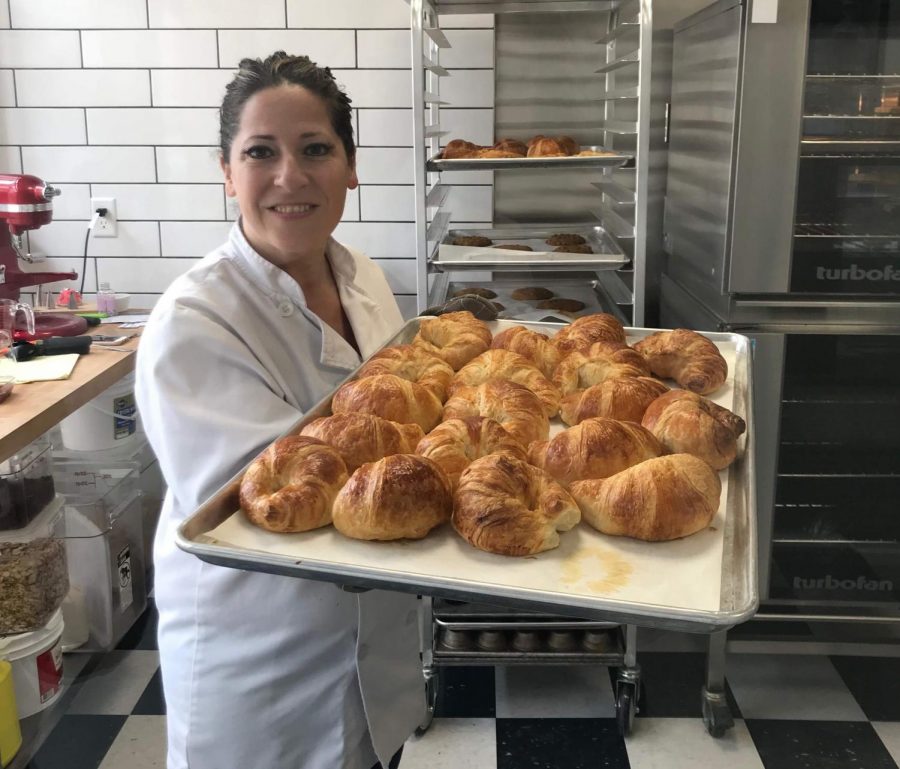 Michelle Kelly, owner and baker of Mademoiselle of Patchogue pictured with a tray of freshly baked croissants.
