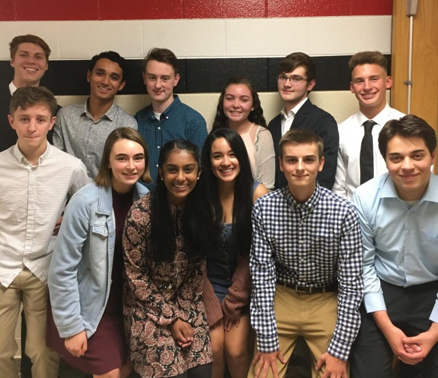 Juniors and seniors pose together backstage before being inducted into the National English Honor Society Wednesday evening.