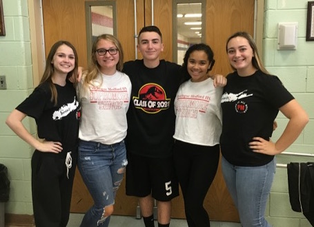From left to right: Brooke (12th grade), Ava, Brendan, and Kristin (all of which are in 10th grade), and Amber (12th grade). As you can see, they are all very excited for homecoming by representing their classes for class shirt day!
