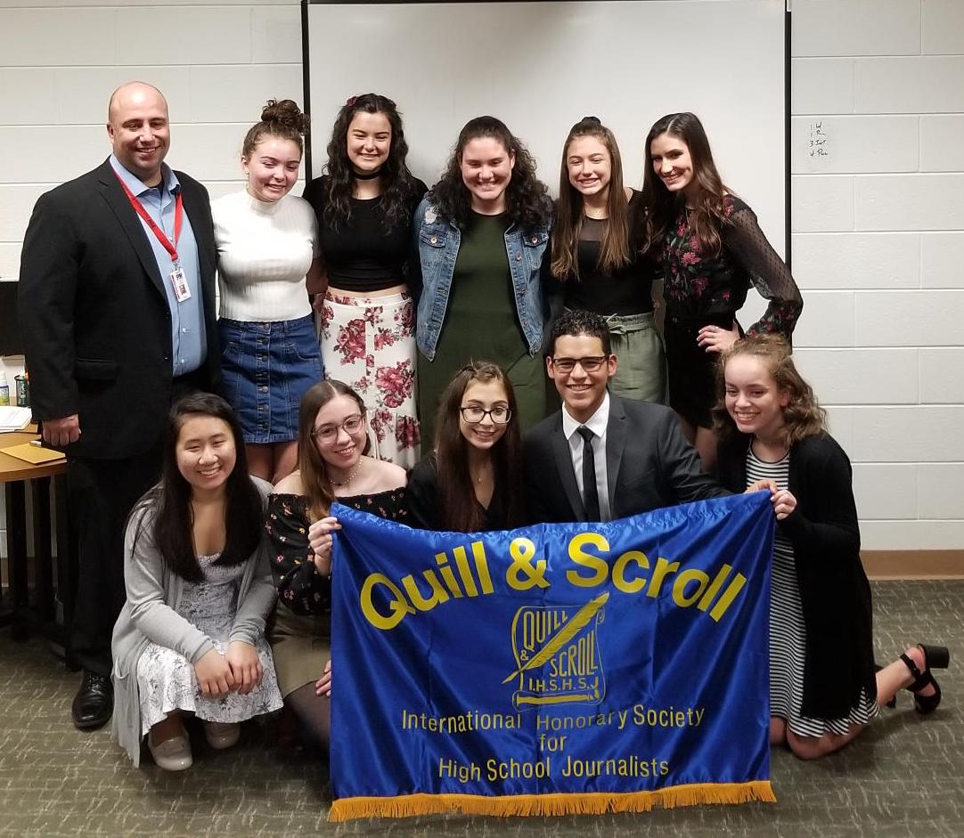 Mr. Hanley, honorary inductee, poses with fellow Quill & Scroll 2018-2019 inductees. Top row from left: Stephanie Sheridan, Delaney Reh, Pelin Bozok, Gianna Gordon, Sarah Bacon. Bottom row from left: Naomi Nyugen, Rute Rodrigues, Nicolette Savattere, Andres Rendon, and Amber Brewer. Congratulations to all!