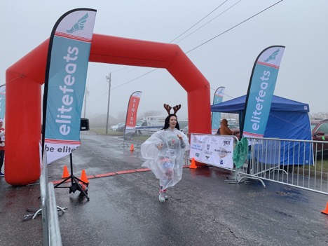 A runner staying dry as she passes the finish line.
