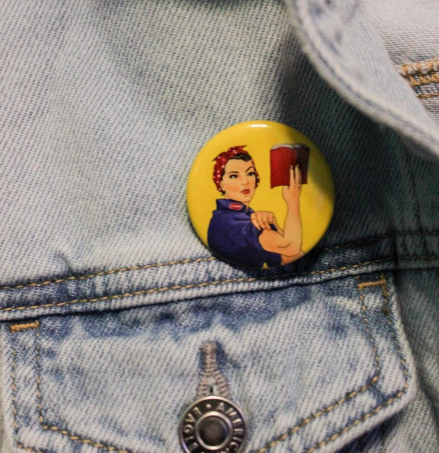 A PMHS student wears pin of Rose the Riveter - a symbol for womens equality. 