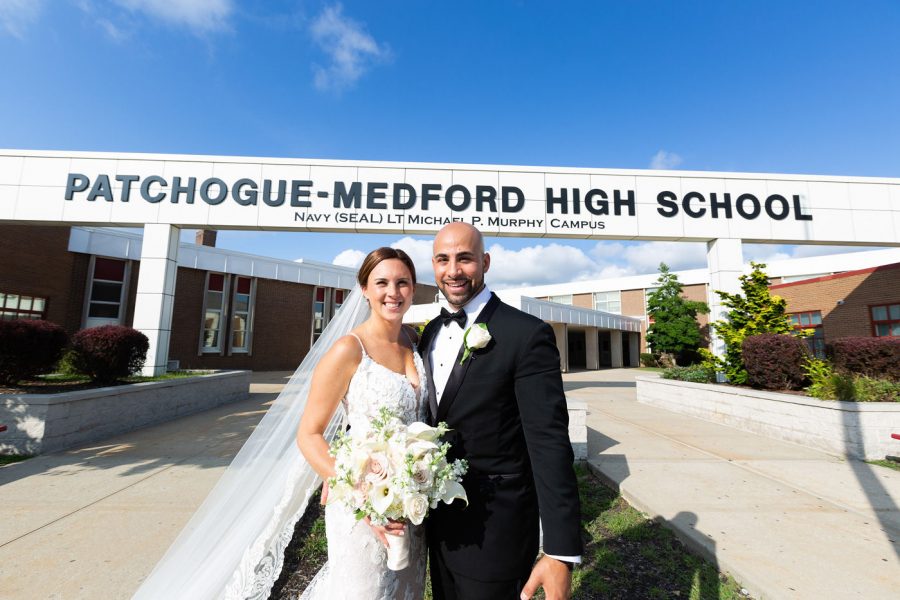 Caitlin and Michael Rattien took some time from their wedding day to capture pictures outside the high school in commemoration of their meeting eleven years prior as high school sweethearts. 