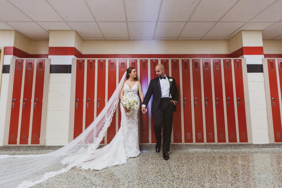 Caitlin and Michael Rattien on their wedding day this past summer pictured in front of the same red lockers and in the halls of the high school where they first met. 