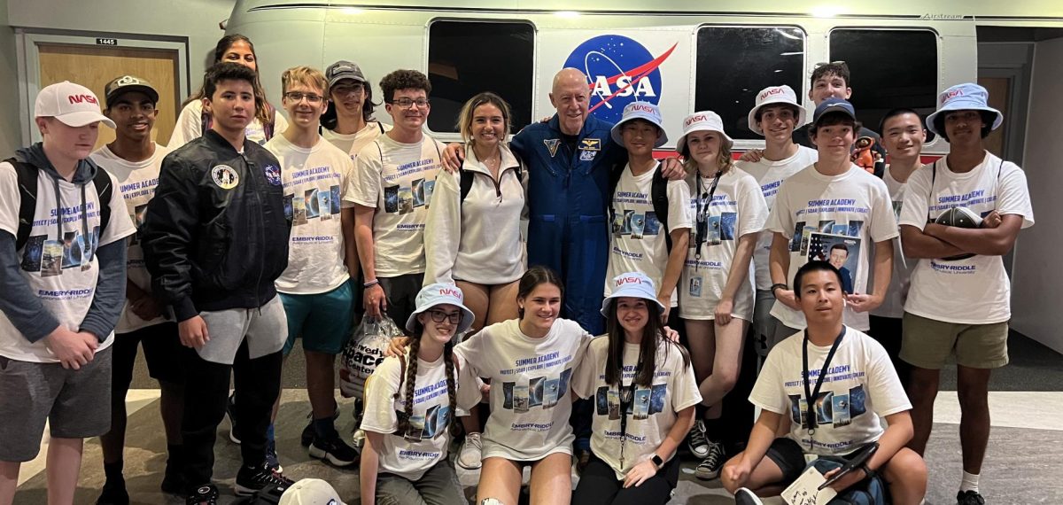 Daniel+Sheridan+with+peers+taking+a+photo+with+astronaut+Mike+Baker+at+Kennedy+Space+Center+in+Cape+Canaveral%2C+FL.+
