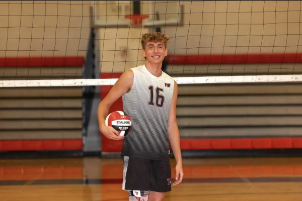 Senior and team captain Julian Frey smiles in front of the net for team pictures at Pat-Med High School. Frey, in addition to being named a Top 50 boys’ volleyball player by Newsday, was featured in Long Island Volleyball’s “Top 10 Boys’ Long Island High School Players to Watch,” being ranked number 8 on the prestigious list (Photo courtesy of Island Photography).