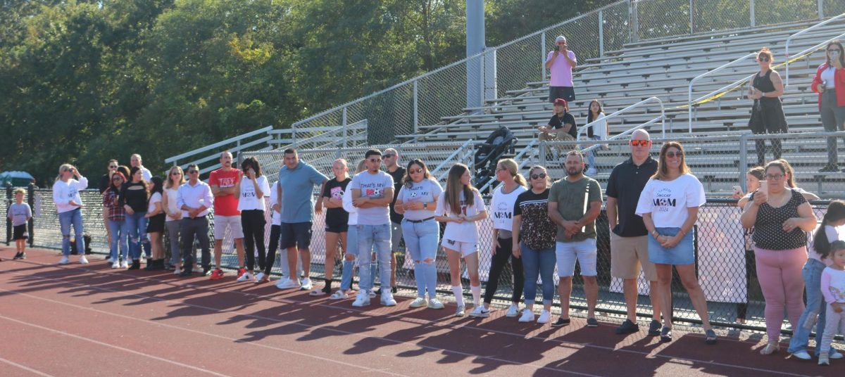 Family members line the track to celebrate senior players final season on Boys Varsity soccer. 