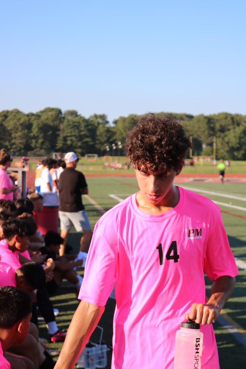 Senior Keith Garcia comes off the field for the Raiders and greets his teammates after scoring a goal in Pat-Meds 5-1 victory against Riverhead. 