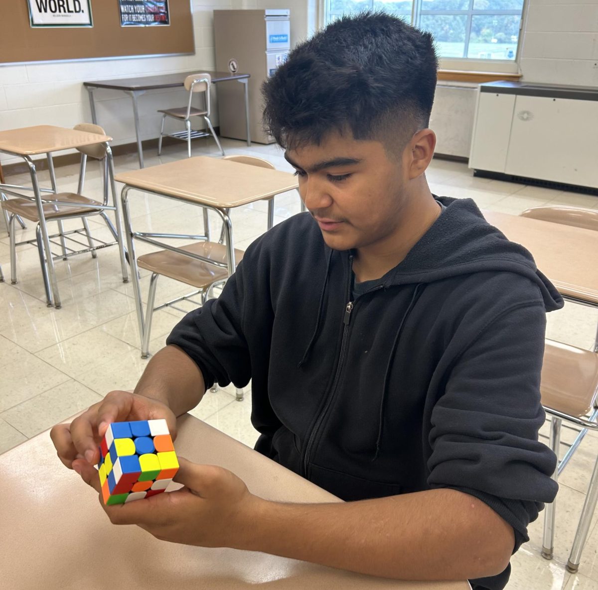 Expert speed-cuber Andrew Fuentes solves the puzzle scrambled by his classmate.