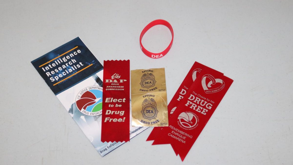 Items given out to students, including bookmarks, bracelets, pens, pamphlets and a signature red ribbon. 