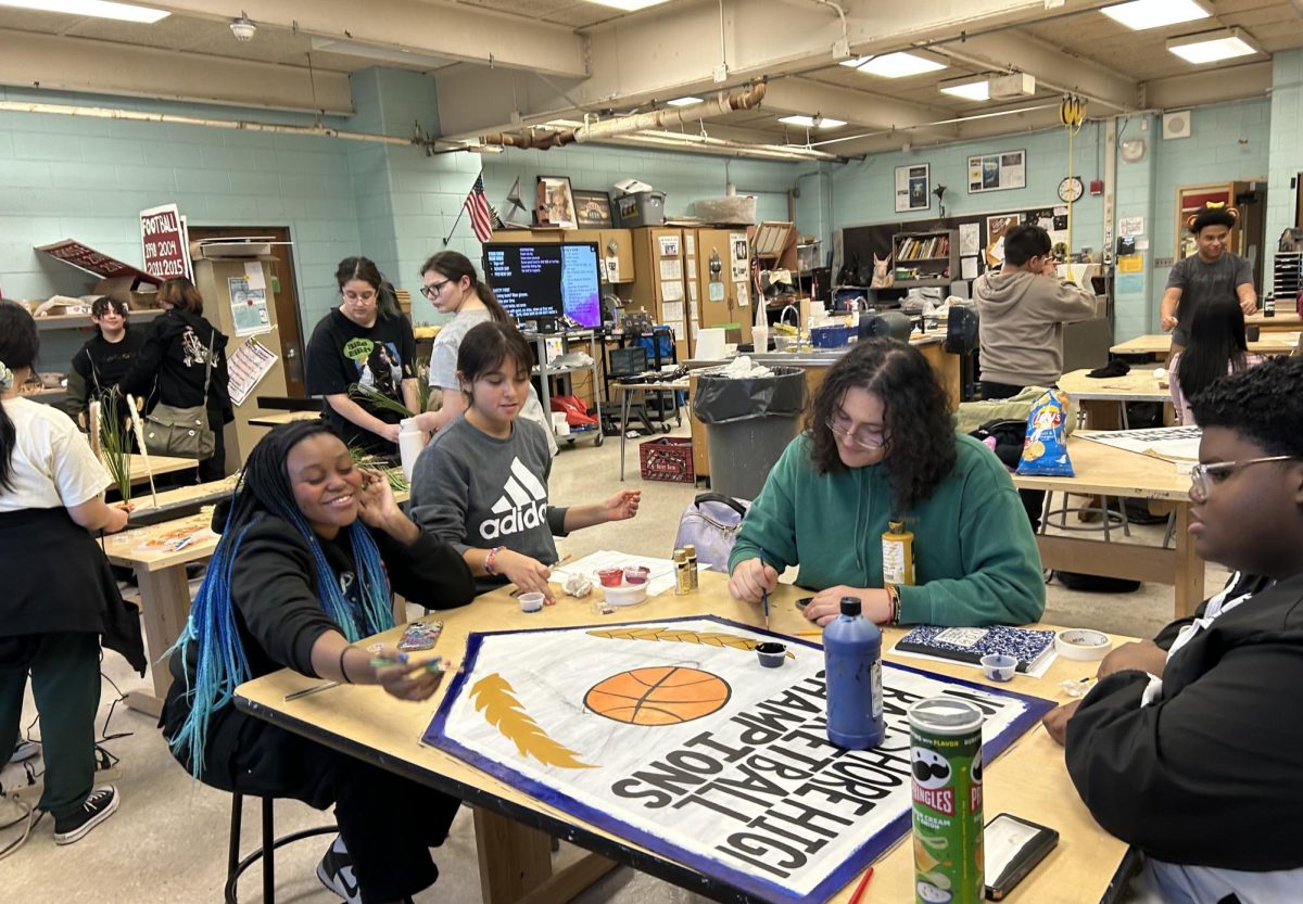  Members of Stage Crew work hard while painting banners and building sets for this year's All-School Musical, Mean Girls: High School Version. Be sure to get your tickets ($15) for Feb. 6, 7, or 8.