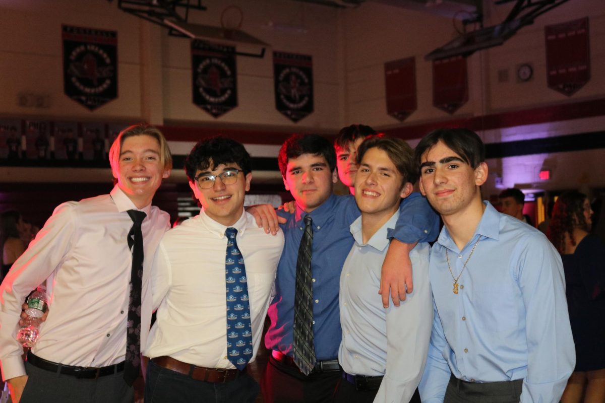 PMHS boys attending the winter semi formal pause their dancing to take a quick photo.