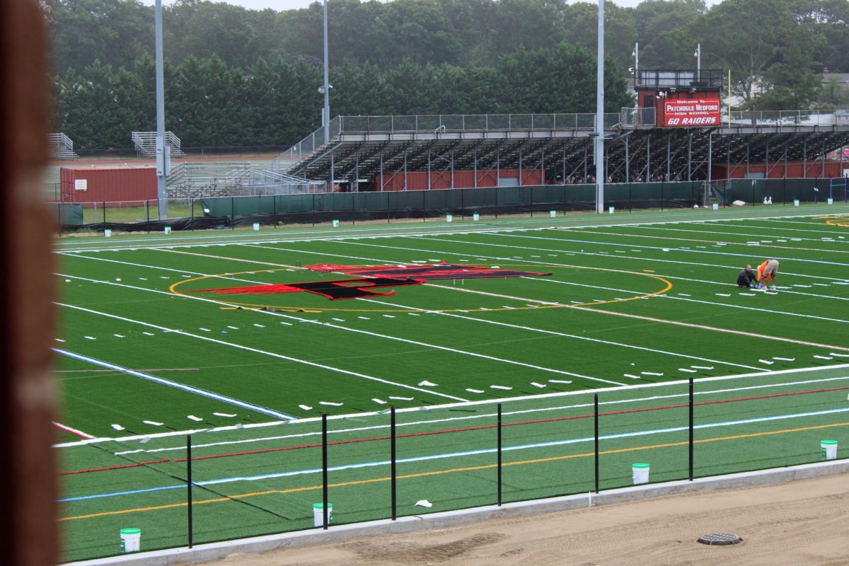 It’s no secret that the Patchogue-Medford community is excited for our new athletics facilities and upgrades to our stages. Thanks to the 2024 Bond Vote, there are new upgrades to our athletic fields and arts and music facilities. A new turf field is being installed in the back of the building on the old soccer field, along with new stadium seating on both fields and an upgraded press box. Thanks to the support of our school district and our community, these upgrades will be phased in over the next few years. In addition, the performance spaces at our secondary schools are being upgraded to brand-new ETC light fixtures and a premium sound system to match industry standard tools and equipment. These purchases are being made in order to help our students hone new skills and to inspire them for future careers. Dr. R states that “We feel that our new facilities are going to be a game changer with regards to our programs, that will soon have access to a quality and professional field, and I'm excited about it. I think it's going to be a great experience once it's all completed. Our new Turf field is coming together! Crews are busy adding in the lines, numbers and the classic Patchogue-Medford logo to center-field as a part of the district’s bond referendum. Dr. R is very excited for what these new facilities have to offer. 