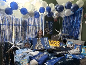 A tradition that many people have started -- here I am sitting on my bed that's covered with SUNY Geneseo merchandise.