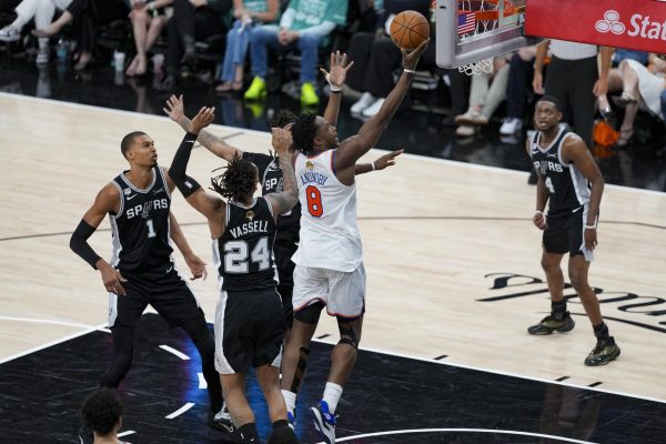 Jun 3, 2026; San Antonio, Texas, USA; New York Knicks forward Og Anunoby (8) drives to the basket past San Antonio Spurs guard Devin Vassell (24) during the fourth quarter during game one of the 2026 NBA Finals at Frost Bank Center. Mandatory Credit: Daniel Dunn-Imagn Images